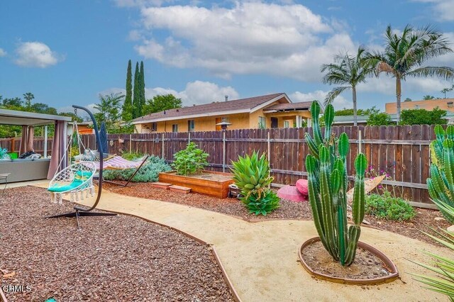  - view of yard featuring a vegetable garden and a patio