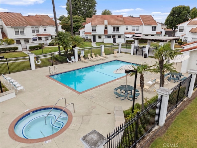 9765 Alburtis Ave Unit 131, Santa Fe Springs, CA 90670 - community pool featuring a hot tub, a patio, and a residential view