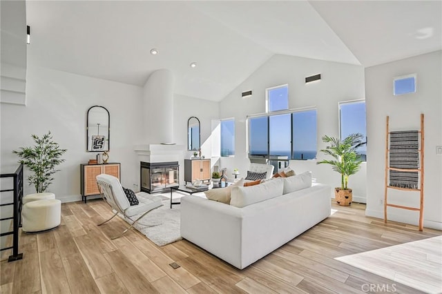 4216 Highland Ave Unit B, Manhattan Beach, CA 90266 - living room featuring light wood finished floors, high vaulted ceiling, and a glass covered fireplace