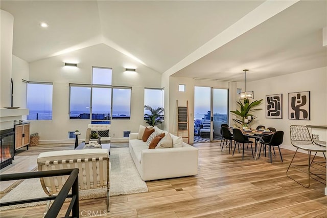 4216 Highland Ave Unit B, Manhattan Beach, CA 90266 - living area featuring vaulted ceiling, light wood-style floors, and a glass covered fireplace
