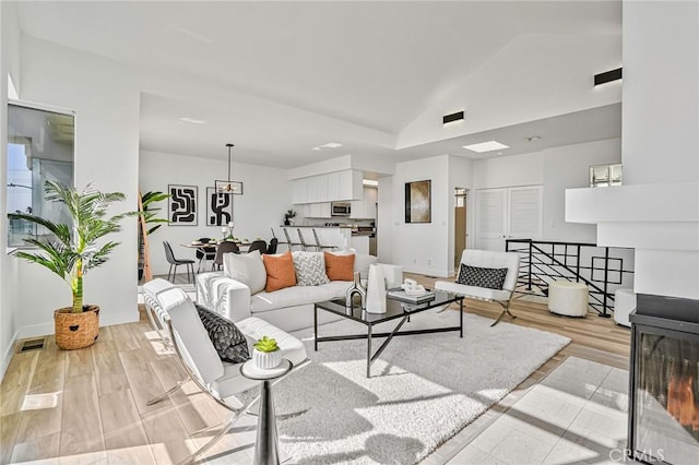 4216 Highland Ave Unit B, Manhattan Beach, CA 90266 - living area with vaulted ceiling and light wood-style floors