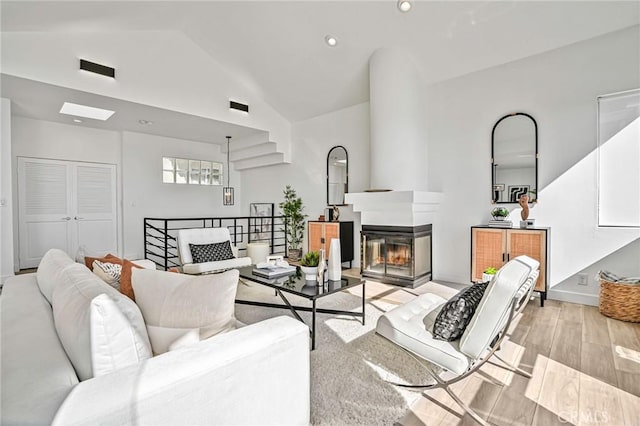 4216 Highland Ave Unit B, Manhattan Beach, CA 90266 - living area featuring a multi sided fireplace, lofted ceiling, light wood-type flooring, and recessed lighting