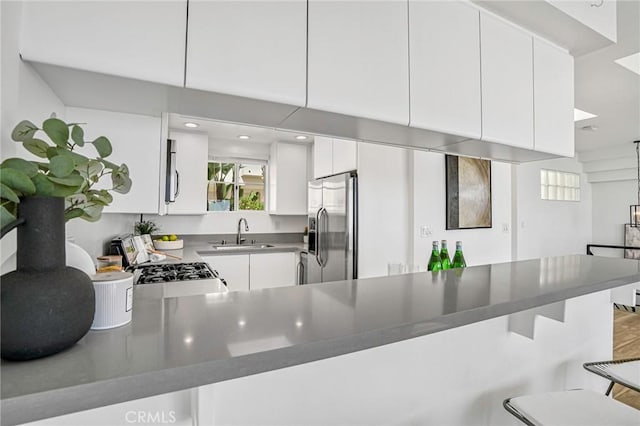 4216 Highland Ave Unit B, Manhattan Beach, CA 90266 - kitchen with appliances with stainless steel finishes, a kitchen bar, a peninsula, plenty of natural light, and recessed lighting