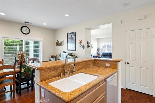 253 Kieswetter St, Colton, CA 92324 - kitchen with white dishwasher, dark wood-style flooring, light stone counters, recessed lighting, and an island with sink
