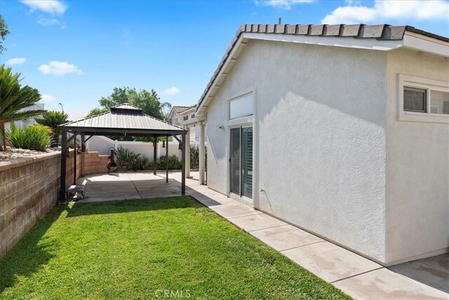 253 Kieswetter St, Colton, CA 92324 - view of property exterior with a patio, a gazebo, a fenced backyard, and stucco siding