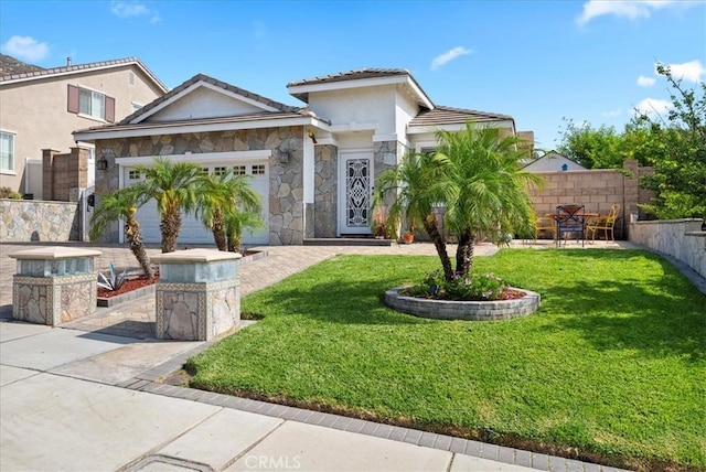 253 Kieswetter St, Colton, CA 92324 - view of front of home featuring an attached garage, stone siding, stucco siding, and a tile roof