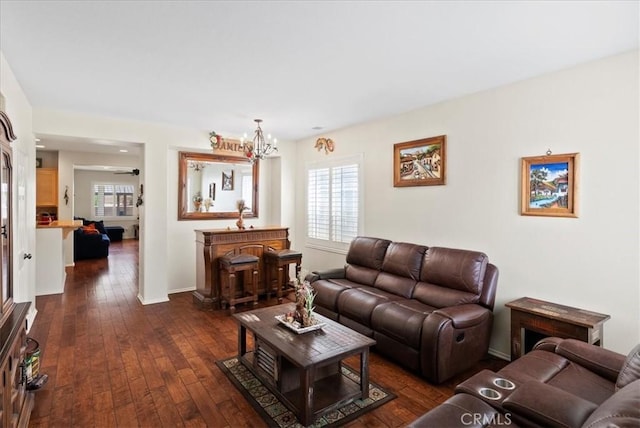 253 Kieswetter St, Colton, CA 92324 - living area featuring healthy amount of natural light, dark wood finished floors, and a chandelier