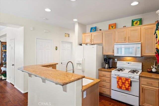253 Kieswetter St, Colton, CA 92324 - kitchen with white appliances, dark wood-style floors, an island with sink, light stone counters, and recessed lighting