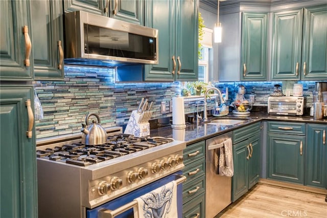 7695 Valle Ave, Atascadero, CA 93422 - kitchen featuring stainless steel appliances, decorative backsplash, green cabinetry, pendant lighting, and light wood finished floors