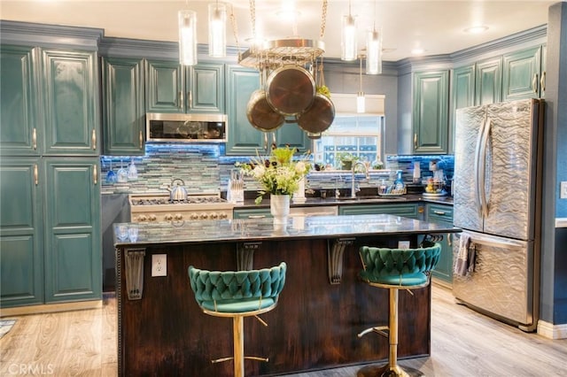 7695 Valle Ave, Atascadero, CA 93422 - bar with stainless steel appliances, backsplash, light wood-style floors, pendant lighting, and ornamental molding