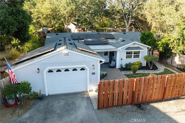 7695 Valle Ave, Atascadero, CA 93422 - ranch-style house with roof mounted solar panels and driveway