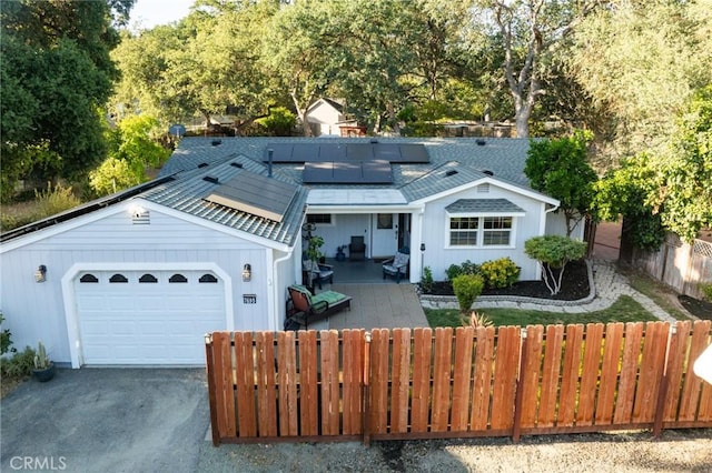 7695 Valle Ave, Atascadero, CA 93422 - view of front of home with solar panels, asphalt driveway, and an attached garage