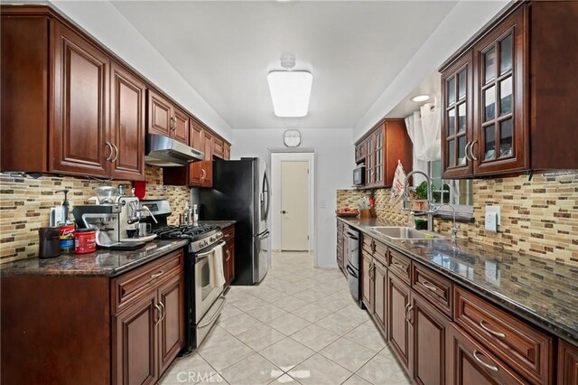 2415 Casa Grande St, Pasadena, CA 91104 - kitchen featuring under cabinet range hood, stainless steel appliances, decorative backsplash, glass insert cabinets, and light tile patterned flooring
