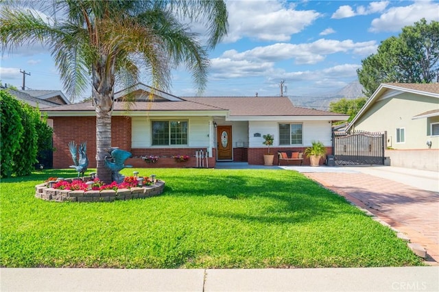 2415 Casa Grande St, Pasadena, CA 91104 - ranch-style home with brick siding, a front yard, and driveway