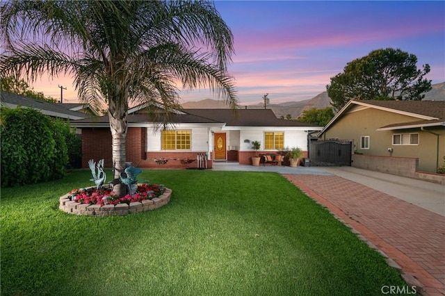 2415 Casa Grande St, Pasadena, CA 91104 - view of front facade featuring brick siding, a lawn, and driveway