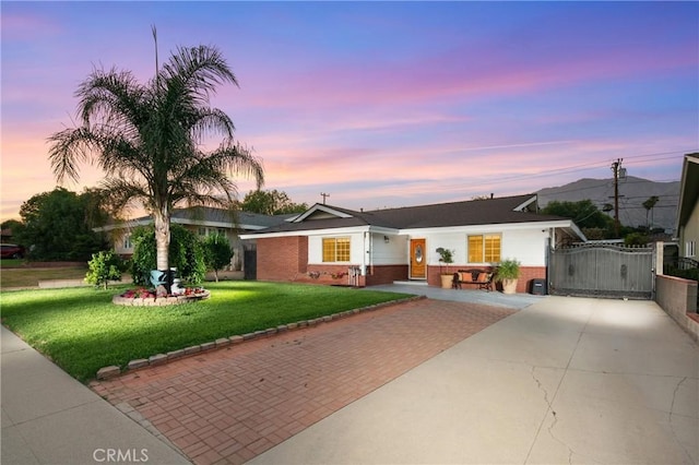 2415 Casa Grande St, Pasadena, CA 91104 - ranch-style home with brick siding, a yard, a gate, and driveway