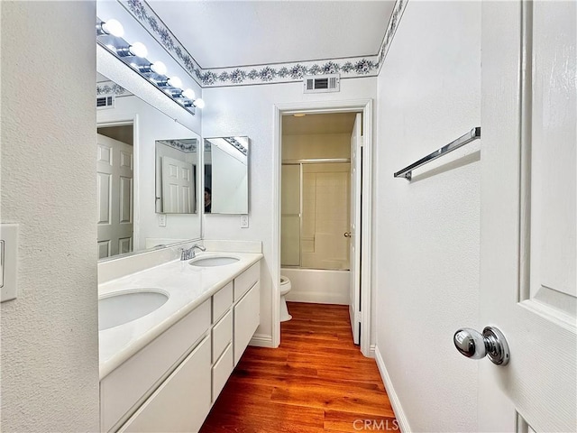 13128 Pintail Ct, Chino, CA 91710 - bathroom with wood finished floors, double vanity, washtub / shower combination, and a textured wall