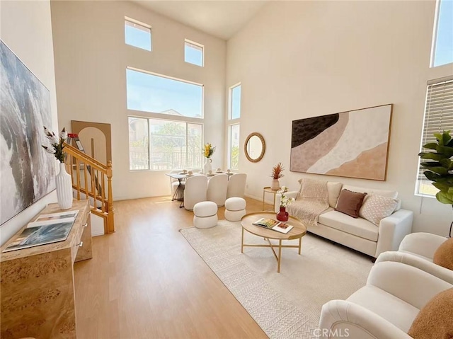 13128 Pintail Ct, Chino, CA 91710 - living room with wood finished floors, a towering ceiling, and stairway