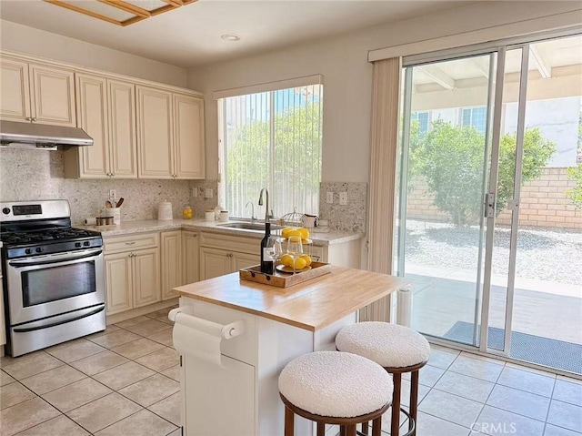 13128 Pintail Ct, Chino, CA 91710 - kitchen featuring stainless steel gas range, under cabinet range hood, light countertops, and light tile patterned floors