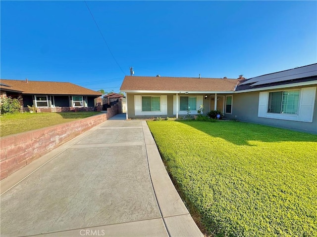 3425 Clifton Ave, Highland, CA 92346 - ranch-style home with a front yard, roof mounted solar panels, stucco siding, and driveway