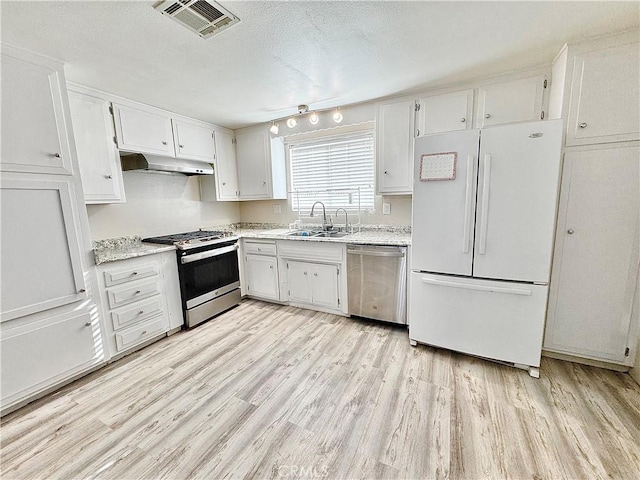 3425 Clifton Ave, Highland, CA 92346 - kitchen with stainless steel appliances, light wood-style flooring, white cabinets, under cabinet range hood, and a textured ceiling