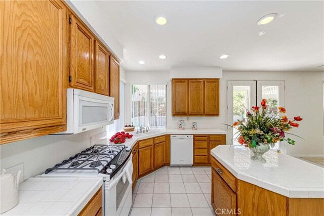 5412 Signac Ct, Chino Hills, CA 91709 - kitchen featuring white appliances, tile countertops, brown cabinetry, recessed lighting, and light tile patterned flooring