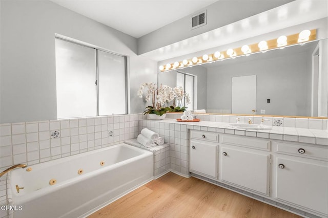 1200 S Orange Grove Blvd Unit 15, Pasadena, CA 91105 - full bath with wood finished floors, a whirlpool tub, and vanity