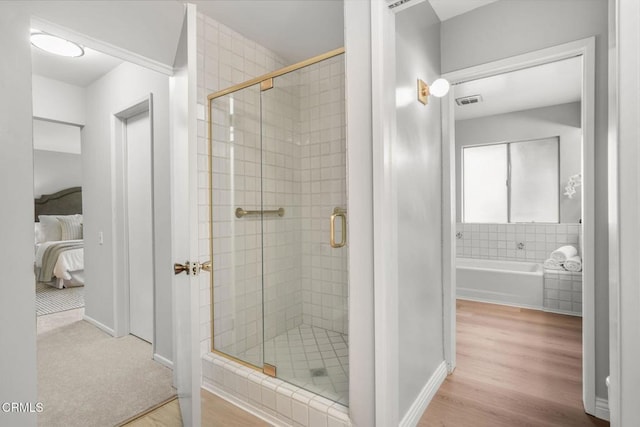 1200 S Orange Grove Blvd Unit 15, Pasadena, CA 91105 - ensuite bathroom featuring a stall shower, a bath, and wood finished floors