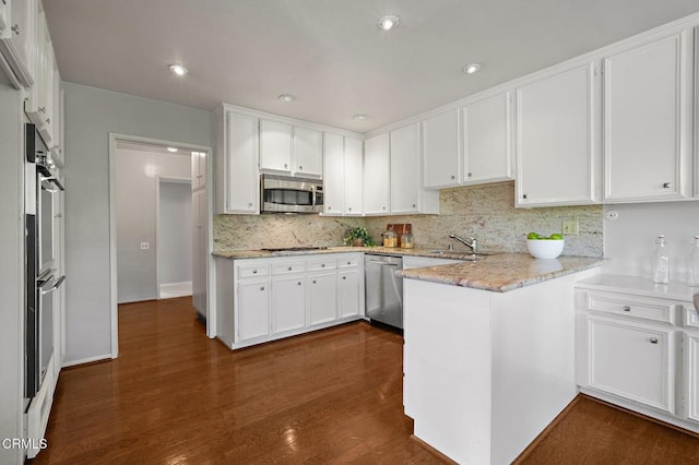 1200 S Orange Grove Blvd Unit 15, Pasadena, CA 91105 - kitchen featuring stainless steel appliances, a peninsula, white cabinetry, decorative backsplash, and recessed lighting