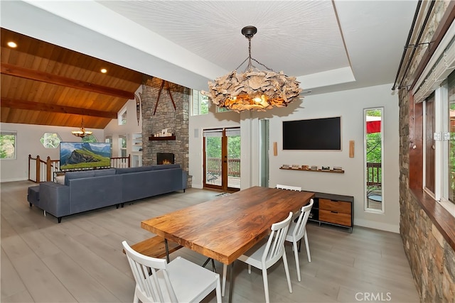 24586 Horst Dr, Crestline, CA 92325 - dining space with a chandelier, light wood-style floors, and a fireplace