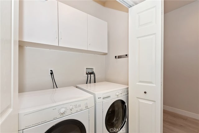 24586 Horst Dr, Crestline, CA 92325 - laundry area featuring cabinet space, washer and clothes dryer, and light wood finished floors
