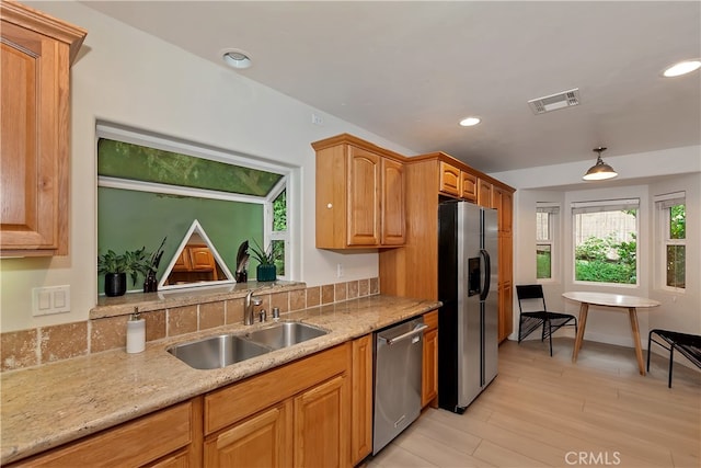 24586 Horst Dr, Crestline, CA 92325 - kitchen with appliances with stainless steel finishes, recessed lighting, light wood finished floors, light stone countertops, and decorative light fixtures