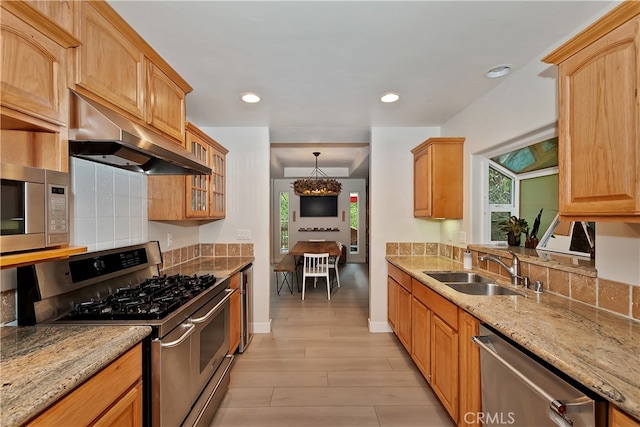 24586 Horst Dr, Crestline, CA 92325 - kitchen with stainless steel appliances, under cabinet range hood, light stone countertops, healthy amount of natural light, and recessed lighting