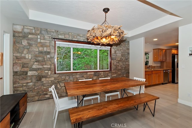 24586 Horst Dr, Crestline, CA 92325 - dining area with a tray ceiling, a chandelier, and light wood finished floors
