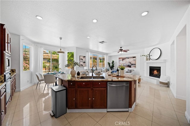 7265 Excelsior Dr, Eastvale, CA 92880 - kitchen featuring stainless steel appliances, a center island with sink, healthy amount of natural light, open floor plan, and recessed lighting