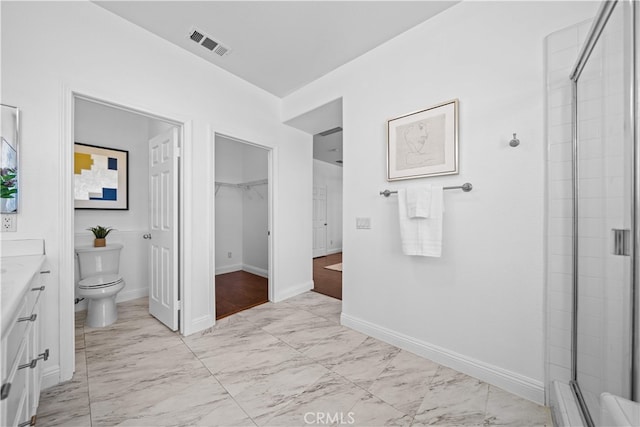 7265 Excelsior Dr, Eastvale, CA 92880 - bathroom with marble finish flooring, vanity, a shower with door, and a walk in closet