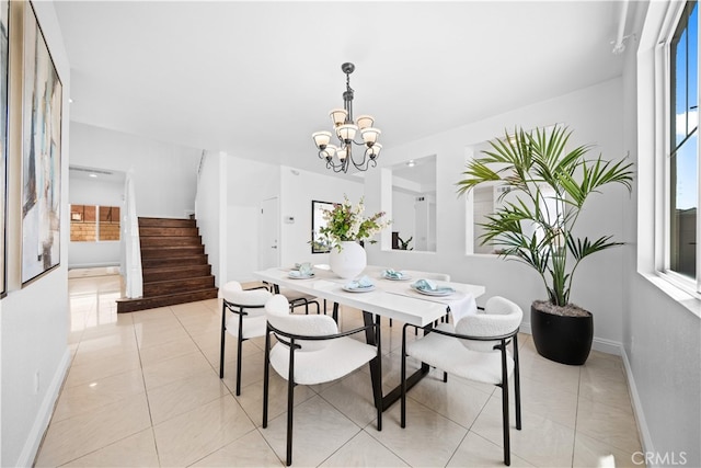 7265 Excelsior Dr, Eastvale, CA 92880 - dining area with stairs, a chandelier, and light tile patterned floors