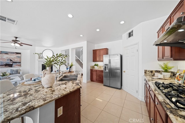 7265 Excelsior Dr, Eastvale, CA 92880 - kitchen with appliances with stainless steel finishes, under cabinet range hood, a ceiling fan, light stone countertops, and recessed lighting