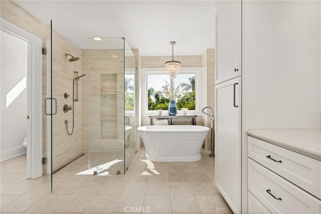 19180 Palm Vis, Yorba Linda, CA 92886 - bathroom with a freestanding bath, a shower stall, a chandelier, and tile patterned floors