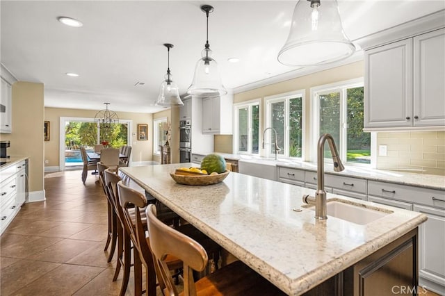 19180 Palm Vis, Yorba Linda, CA 92886 - kitchen with backsplash, recessed lighting, tile patterned flooring, hanging light fixtures, and a kitchen bar