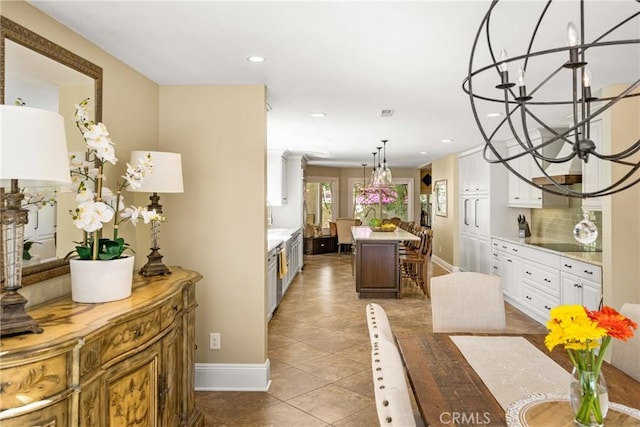 19180 Palm Vis, Yorba Linda, CA 92886 - kitchen with white cabinetry, a kitchen island, light countertops, decorative backsplash, and a chandelier