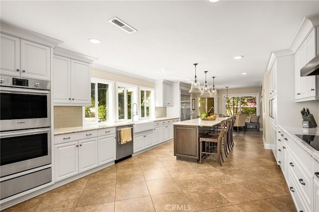 19180 Palm Vis, Yorba Linda, CA 92886 - kitchen with stainless steel appliances, decorative backsplash, white cabinets, recessed lighting, and crown molding