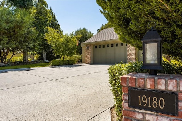 19180 Palm Vis, Yorba Linda, CA 92886 - view of front of home featuring an outdoor structure, brick siding, and a detached garage