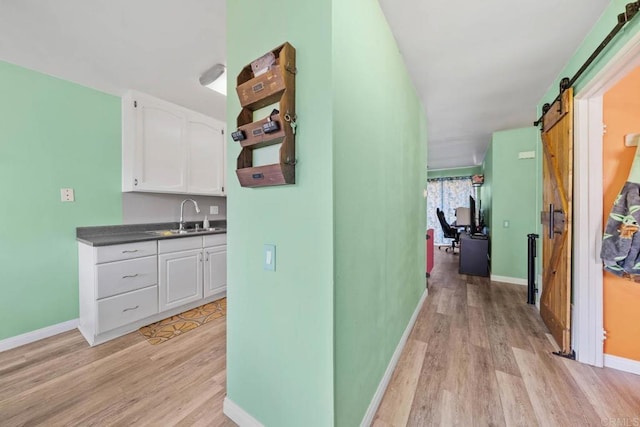 218 Holiday Way, Oceanside, CA 92057 - hall with a barn door, light wood-type flooring, and a desk