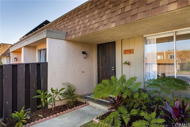 218 Holiday Way, Oceanside, CA 92057 - entrance to property featuring roof with shingles, mansard roof, and stucco siding