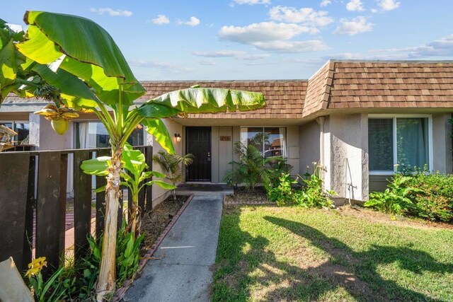218 Holiday Way, Oceanside, CA 92057 - view of exterior entry with mansard roof, stucco siding, and a shingled roof