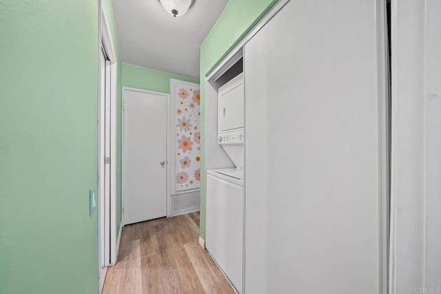 218 Holiday Way, Oceanside, CA 92057 - laundry area with stacked washer / dryer and light wood-style flooring