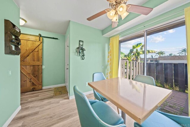 218 Holiday Way, Oceanside, CA 92057 - dining space featuring a barn door, wood finished floors, and ceiling fan