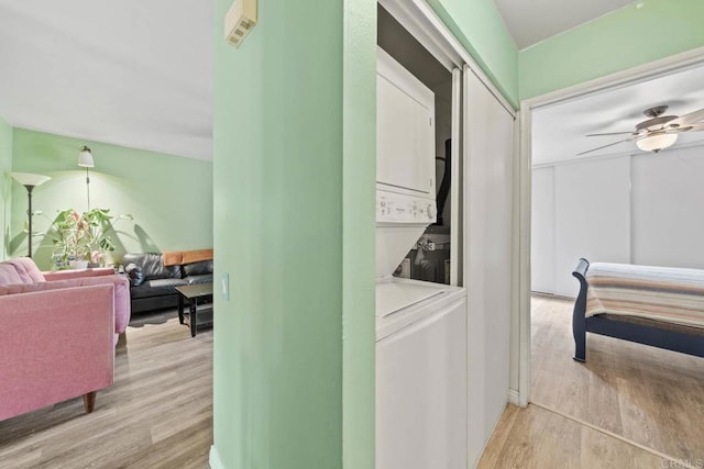 218 Holiday Way, Oceanside, CA 92057 - laundry area featuring stacked washer / dryer, light wood-type flooring, and ceiling fan
