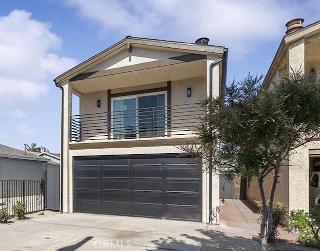 15016 Firmona Ave, Lawndale, CA 90260 - view of front of property featuring concrete driveway, stucco siding, a balcony, and an attached garage